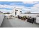 Expansive rooftop deck featuring comfortable outdoor seating, dining area, and stylish decor against a bright, cloudy sky at 1256 Xavier St, Denver, CO 80204
