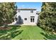 Backyard view of the home showcasing well-maintained lawn and mature trees at 10894 Depew Pl, Westminster, CO 80020