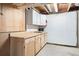 Basement featuring cabinet space and pegboard wall for storage at 10894 Depew Pl, Westminster, CO 80020