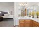 Well-lit bathroom featuring a double sink vanity and a glass-enclosed shower next to the soaking tub at 10894 Depew Pl, Westminster, CO 80020