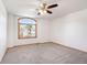 Bedroom featuring neutral walls, carpet floors, a closet and an arched window with wooden blinds at 10894 Depew Pl, Westminster, CO 80020