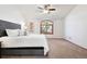 Bedroom features soft carpet, large windows, and a comfortable bed, creating a serene atmosphere at 10894 Depew Pl, Westminster, CO 80020