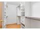 Spacious walk-in closet with custom shelving and drawers for optimal storage and organization at 10894 Depew Pl, Westminster, CO 80020