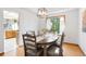 Cozy dining area with hardwood floors, a modern chandelier, and views into the adjacent kitchen at 10894 Depew Pl, Westminster, CO 80020
