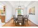 Elegant dining room with a tray ceiling, hardwood floors, and an open view into the kitchen at 10894 Depew Pl, Westminster, CO 80020