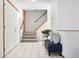 Inviting entryway with tile floors, staircase, and bench seating, creating a welcoming entrance at 10894 Depew Pl, Westminster, CO 80020