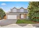Charming two-story home featuring a well-manicured lawn, brick accents, and an attached two-car garage at 10894 Depew Pl, Westminster, CO 80020