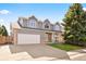 Charming two-story home featuring a brick-accented facade and well-manicured lawn at 10894 Depew Pl, Westminster, CO 80020