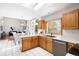Spacious kitchen featuring white countertops, oak cabinets, and an open layout for seamless entertaining at 10894 Depew Pl, Westminster, CO 80020