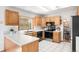 Bright kitchen featuring white countertops, oak cabinetry, and modern stainless steel appliances at 10894 Depew Pl, Westminster, CO 80020