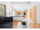 Open-concept living room and kitchen with wood floors, vaulted ceilings, and plenty of natural light at 10894 Depew Pl, Westminster, CO 80020