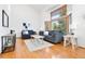 Bright living room with hardwood floors, large windows, and comfortable seating, creating a cozy space at 10894 Depew Pl, Westminster, CO 80020