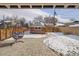 Backyard with brick patio, hanging chair, detached garage, and wooden fence at 3640 Newton St, Denver, CO 80211