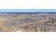 Expansive aerial view showcasing the residential area, mountain backdrop, and highlighting the property's location at 2976 Open Sky Way, Castle Rock, CO 80109
