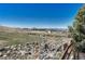 Backyard with rocks, fence, grass and view of mountains in the distance at 2976 Open Sky Way, Castle Rock, CO 80109