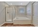 This bathroom features a shower and soaker tub with tile surround, and wood floors at 2976 Open Sky Way, Castle Rock, CO 80109