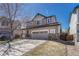 Charming two-story home with a well-manicured lawn, a two-car garage, and a stone-accented facade, perfect for a growing Gathering at 2976 Open Sky Way, Castle Rock, CO 80109