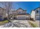 Charming two-story home featuring stone accents, a spacious two-car garage, and a well-manicured front lawn at 2976 Open Sky Way, Castle Rock, CO 80109