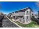 Exterior view of a two-story home featuring a patio and landscaped backyard at 2976 Open Sky Way, Castle Rock, CO 80109