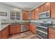 This kitchen features wood cabinets, granite countertops, and stainless appliances at 2976 Open Sky Way, Castle Rock, CO 80109