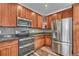 This kitchen features wood cabinets, granite countertops, and stainless appliances at 2976 Open Sky Way, Castle Rock, CO 80109