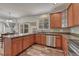 This kitchen features wood cabinets, granite countertops, stainless appliances, and wood floors at 2976 Open Sky Way, Castle Rock, CO 80109