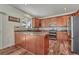 This kitchen features wood cabinets, granite countertops, stainless appliances, and wood floors at 2976 Open Sky Way, Castle Rock, CO 80109