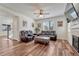 Cozy living room features hardwood floors, a fireplace, and windows that provide ample natural light at 2976 Open Sky Way, Castle Rock, CO 80109