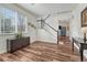 Bright living room with hardwood floors, staircase, and a large window offering ample natural light at 2976 Open Sky Way, Castle Rock, CO 80109