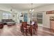 Open-concept living and dining area with hardwood floors, fireplace, and sliding glass doors to the patio at 2976 Open Sky Way, Castle Rock, CO 80109