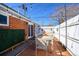 Cozy backyard patio with brick flooring, string lights, and an inviting dining area at 1421 Jasmine St # 1, Denver, CO 80220