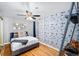 Bedroom with stylish wallpaper, hardwood floors, and a comfortable bed at 1421 Jasmine St # 1, Denver, CO 80220