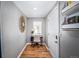 Hallway with small window, wooden floors, a writing desk and book shelves at 1421 Jasmine St # 1, Denver, CO 80220