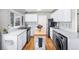 Modern kitchen with white countertops, stainless steel appliances and hardwood floors at 1421 Jasmine St, Denver, CO 80220