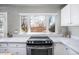 Bright modern kitchen showing stainless steel oven and cooktop with natural light at 1421 Jasmine St # 1, Denver, CO 80220