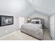 Cozy main bedroom featuring sloped ceilings, plush carpeting, and ample natural light at 1421 Jasmine St, Denver, CO 80220