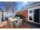 A brick patio with seating, string lights, and a well-manicured fence at 1421 Jasmine St, Denver, CO 80220