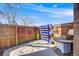 Cozy backyard area features a decorative fence, unique table, and concrete flooring, perfect for relaxing or entertaining guests at 2917 S Locust St, Denver, CO 80222