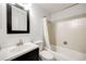 Bathroom featuring a shower-tub combo, a modern vanity, and neutral wall paint at 2917 S Locust St, Denver, CO 80222