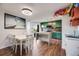 Open concept kitchen and dining area with green cabinets, an island and a view to a covered balcony at 2917 S Locust St, Denver, CO 80222