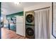 Well-organized kitchen area features a stacked washer/dryer with unique, modern appliances and decor at 2917 S Locust St, Denver, CO 80222