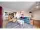 Inviting living room boasts hardwood floors, stylish furniture, and an open layout connecting to the kitchen at 2917 S Locust St, Denver, CO 80222