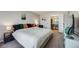 Bright bedroom with large bed, decorative pillows, and an ensuite bathroom at 2917 S Locust St, Denver, CO 80222