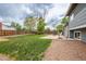 Backyard showing grass area, basketball hoop, and a partially graveled area with hammock at 18472 E Atlantic Dr, Aurora, CO 80013
