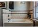 A bathtub surrounded by tile work with a window to allow for plenty of natural lighting at 18472 E Atlantic Dr, Aurora, CO 80013