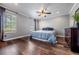 Bright bedroom with hardwood floors, a ceiling fan, and multiple windows at 18472 E Atlantic Dr, Aurora, CO 80013