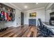 Spacious home office bedroom with hardwood floors and a small open closet for storage at 18472 E Atlantic Dr, Aurora, CO 80013