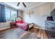 Well-lit bedroom showcases a large window, wood floors, and quaint furniture at 18472 E Atlantic Dr, Aurora, CO 80013
