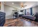 This spacious bedroom contains new hardwood flooring, a large window, and a ceiling fan at 18472 E Atlantic Dr, Aurora, CO 80013