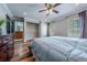 Bedroom featuring a walk-in closet with hardwood floors and warm natural lighting at 18472 E Atlantic Dr, Aurora, CO 80013